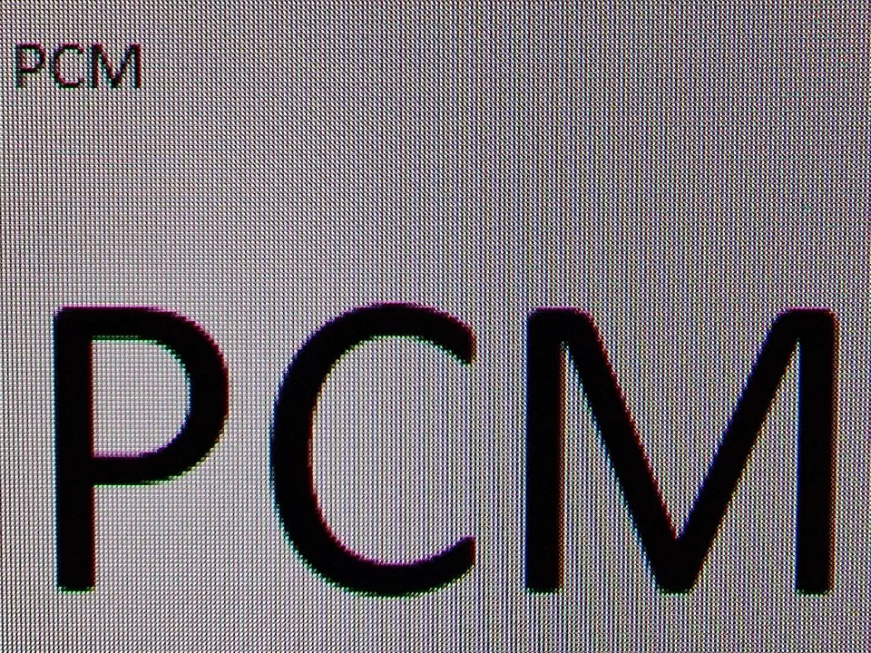 Close-up photo of black text on white background with visible magenta and green color fringing around letter edges on a QD-OLED panel
