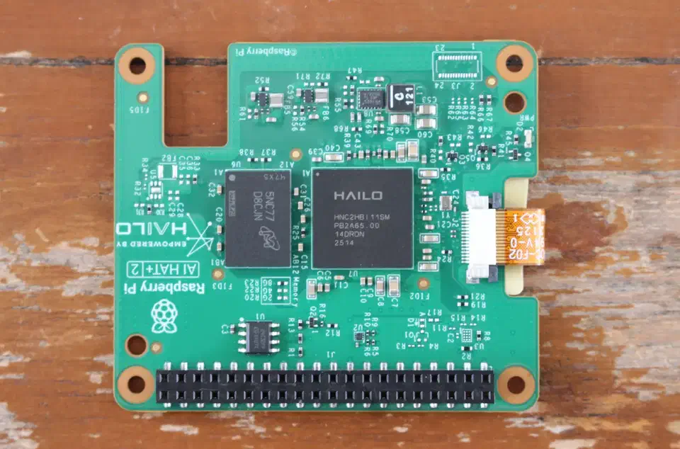 Hailo-10H M.2 accelerator module mounted on the Raspberry Pi AI HAT+ 2 showing the neural-core IC and 8 GB LPDDR4 chip