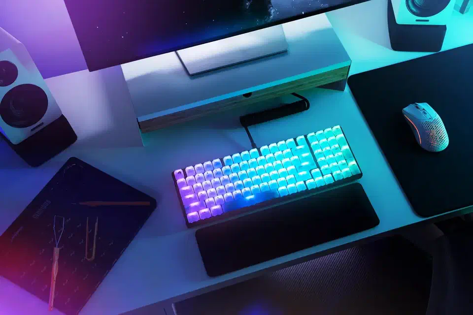 Glorious Polychroma RGB translucent polycarbonate keycaps glowing with rainbow backlight