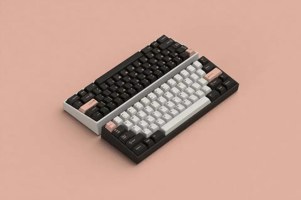 GMK Olivia keycap set showing pink and dark doubleshot ABS caps laid out on a keyboard