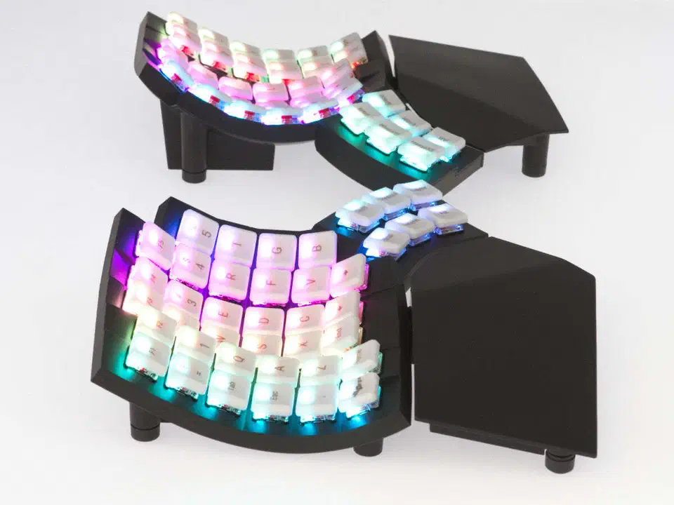 MoErgo Glove80 split ergonomic keyboard showing contoured key wells and RGB lighting