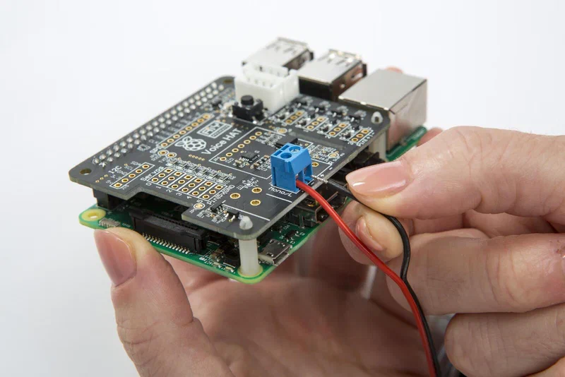 Google AIY Voice HAT assembled on a Raspberry Pi with speaker wires connected to the voice bonnet