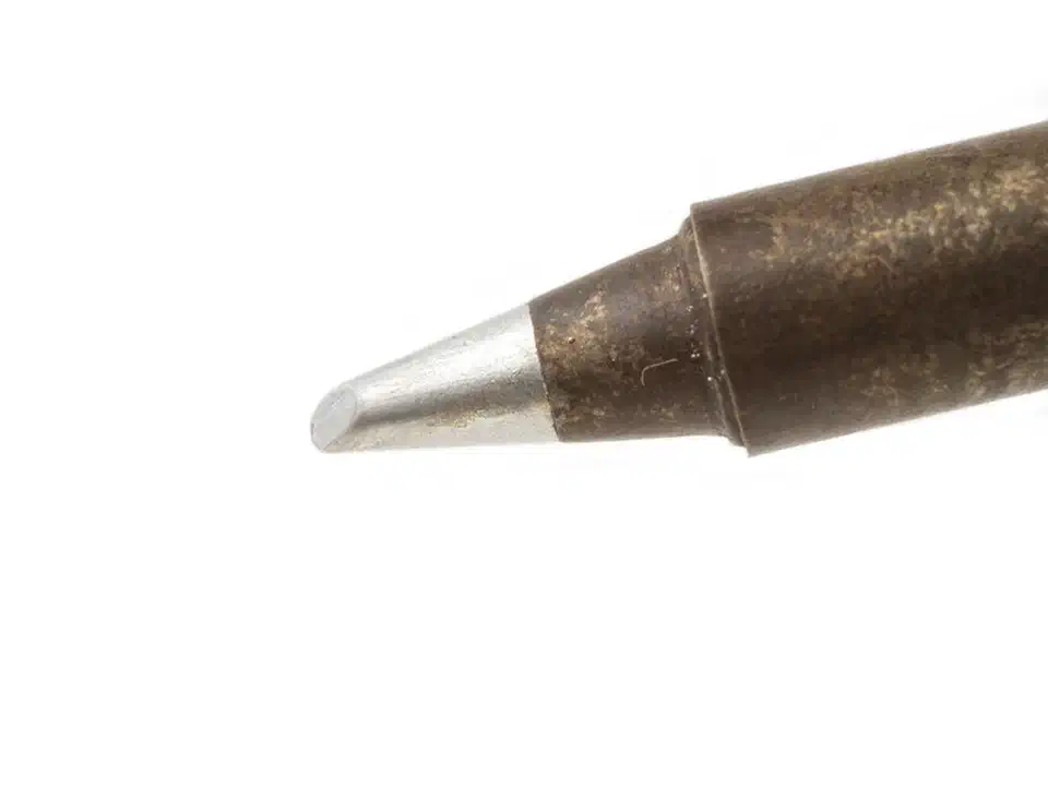 Various soldering iron tip shapes laid out showing conical, chisel, bevel, and wedge types