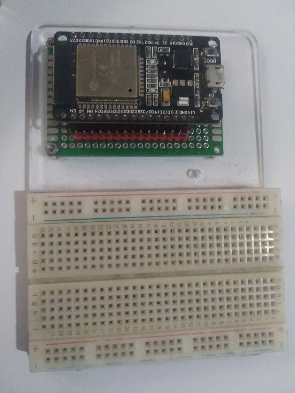 ESP32 development board with visible WROOM module, GPIO pins, and USB connector