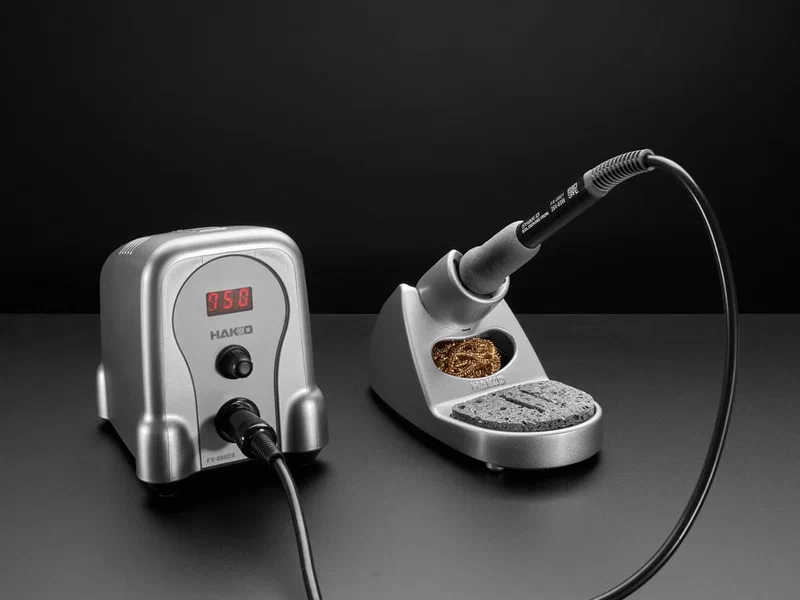 Hakko FX-888D temperature-controlled soldering station with iron holder and brass tip cleaner