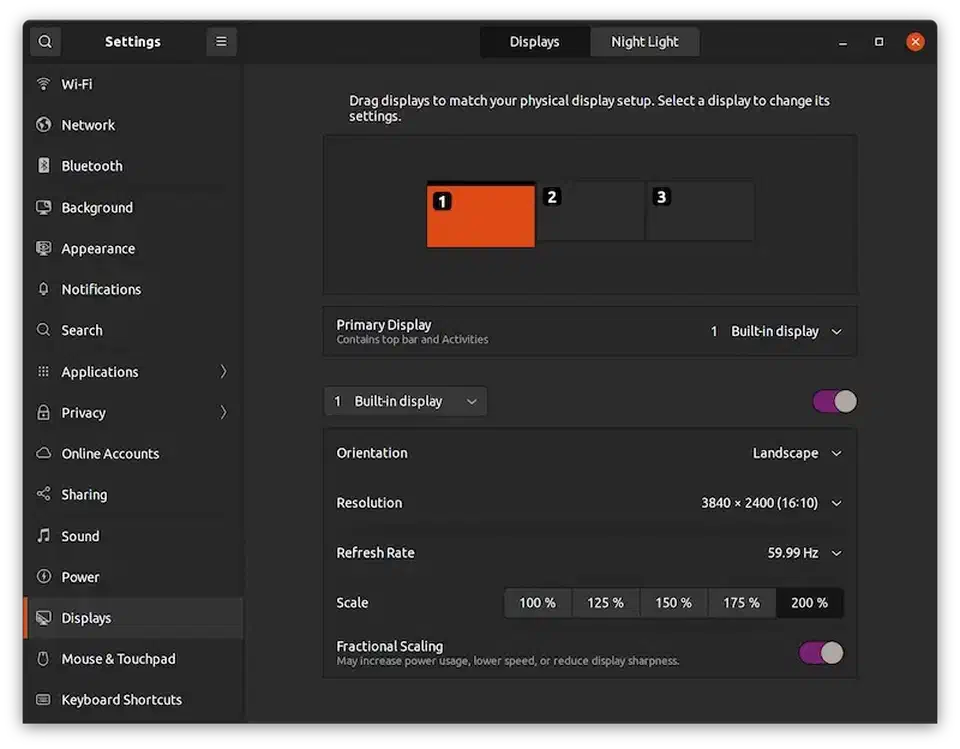 Ubuntu display settings showing fractional scaling with a 4K laptop display at 200% alongside 1080p external monitors at 100%