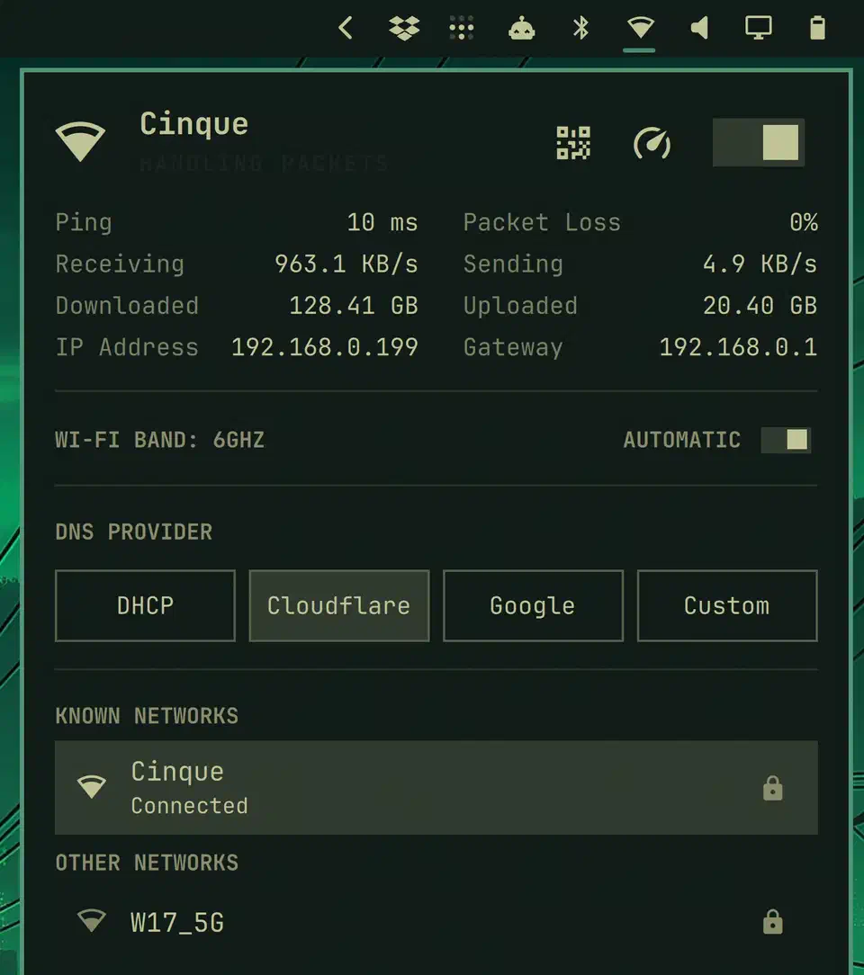 Omarchy network control panel showing the connected Wi-Fi network, live upload and download throughput graphs, ping and packet loss figures, and a DNS provider selector