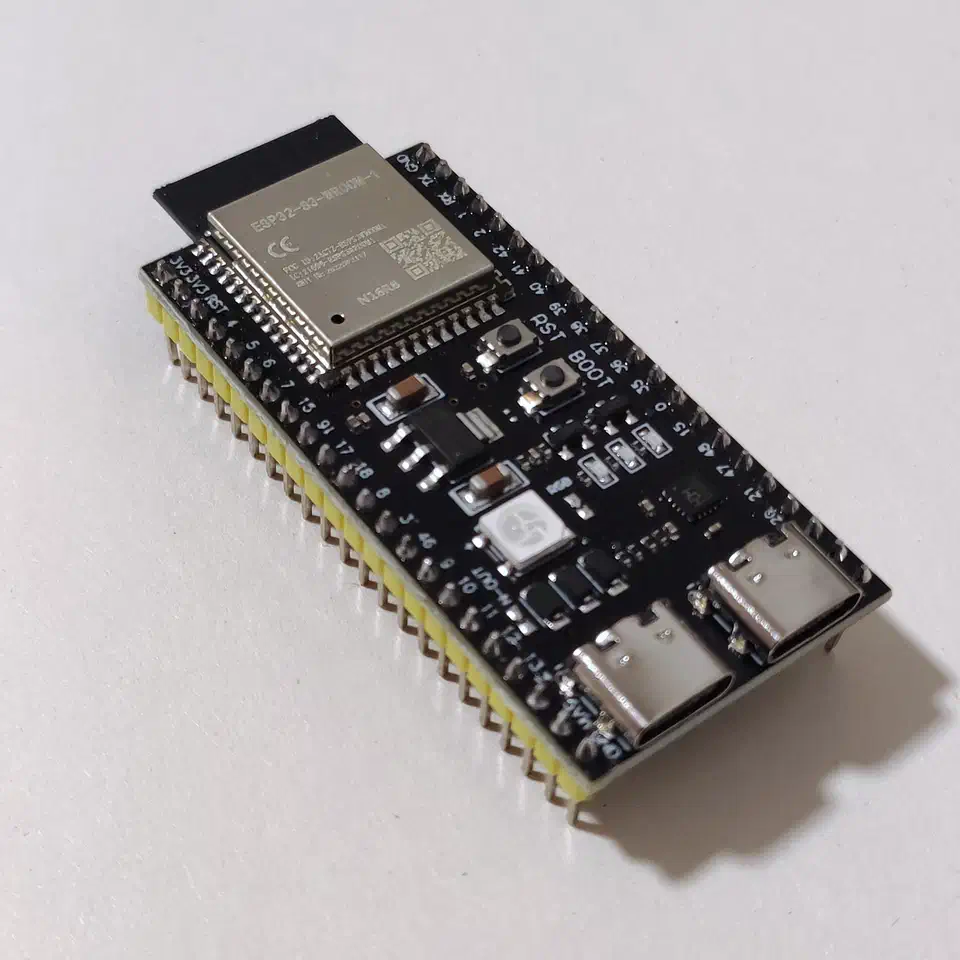 ESP32-S3 development board with visible SoC, USB-C connector, and antenna on a white background