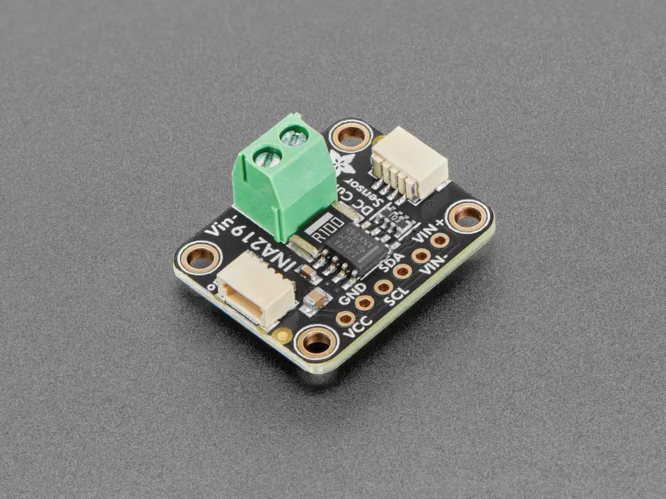 INA219 current sensor breakout board, a small purple PCB with a screw terminal block, STEMMA QT connectors and labelled I2C pins