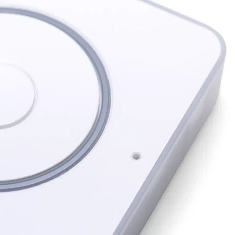 Close-up of the dual MEMS microphone ports on the top of the Voice PE, showing the beamforming mic array