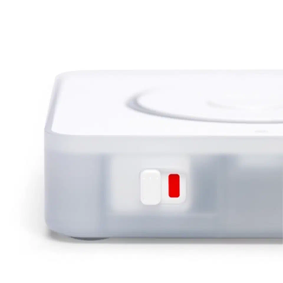 Close-up of the Voice PE hardware mute switch in the muted position, with the solid red LED ring confirming mics are physically cut