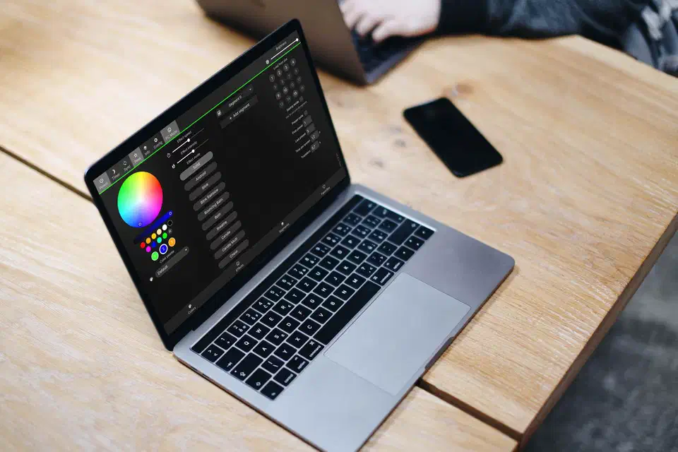 WLED web interface displayed on a MacBook showing the color picker and effects controls